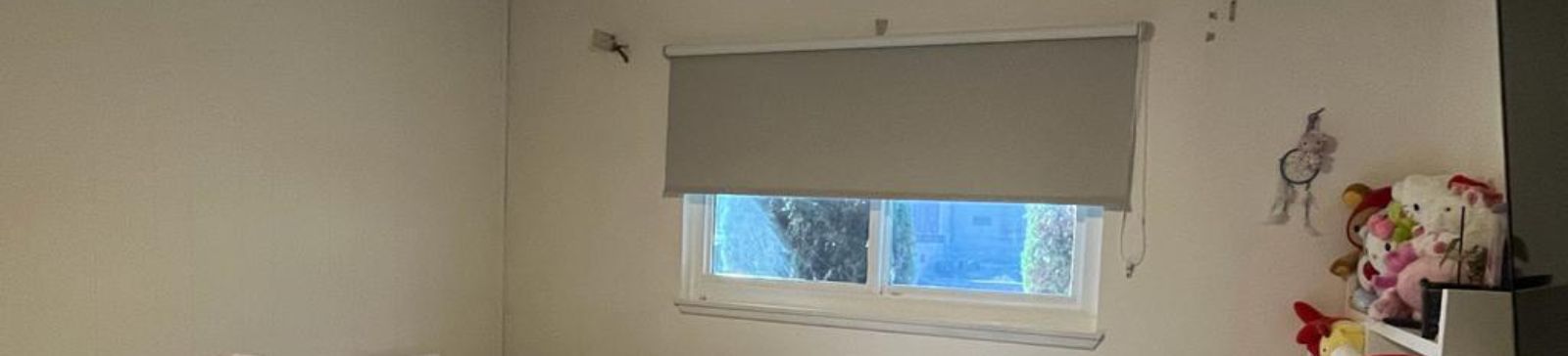 Pull down window shades providing light control and privacy for a child's bedroom.