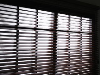 Faux Wooden Blinds | Laguna Niguel Blinds & Shades CA Faux wood blinds adding warmth to a living room window.