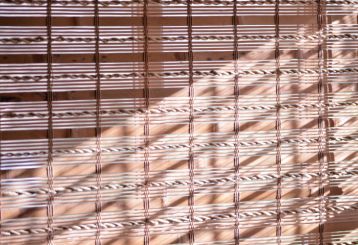 Warm and inviting living room with natural woven wood blinds, providing a touch of nature to the space.