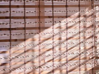 Warm and inviting living room with natural woven wood blinds, providing a touch of nature to the space.